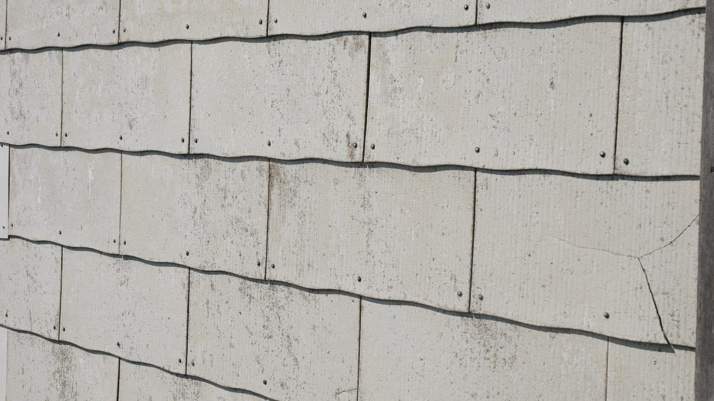 Asbestos cement siding tiles on the exterior wall of a house